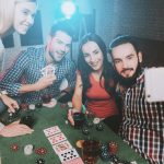 group friends of taking a selfie while enjoying a game of poker
