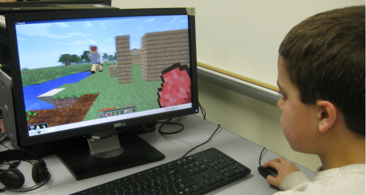 child playing minecraft videogame