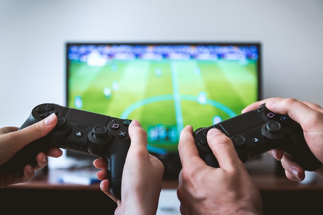 Two boys playing video games with controllers.