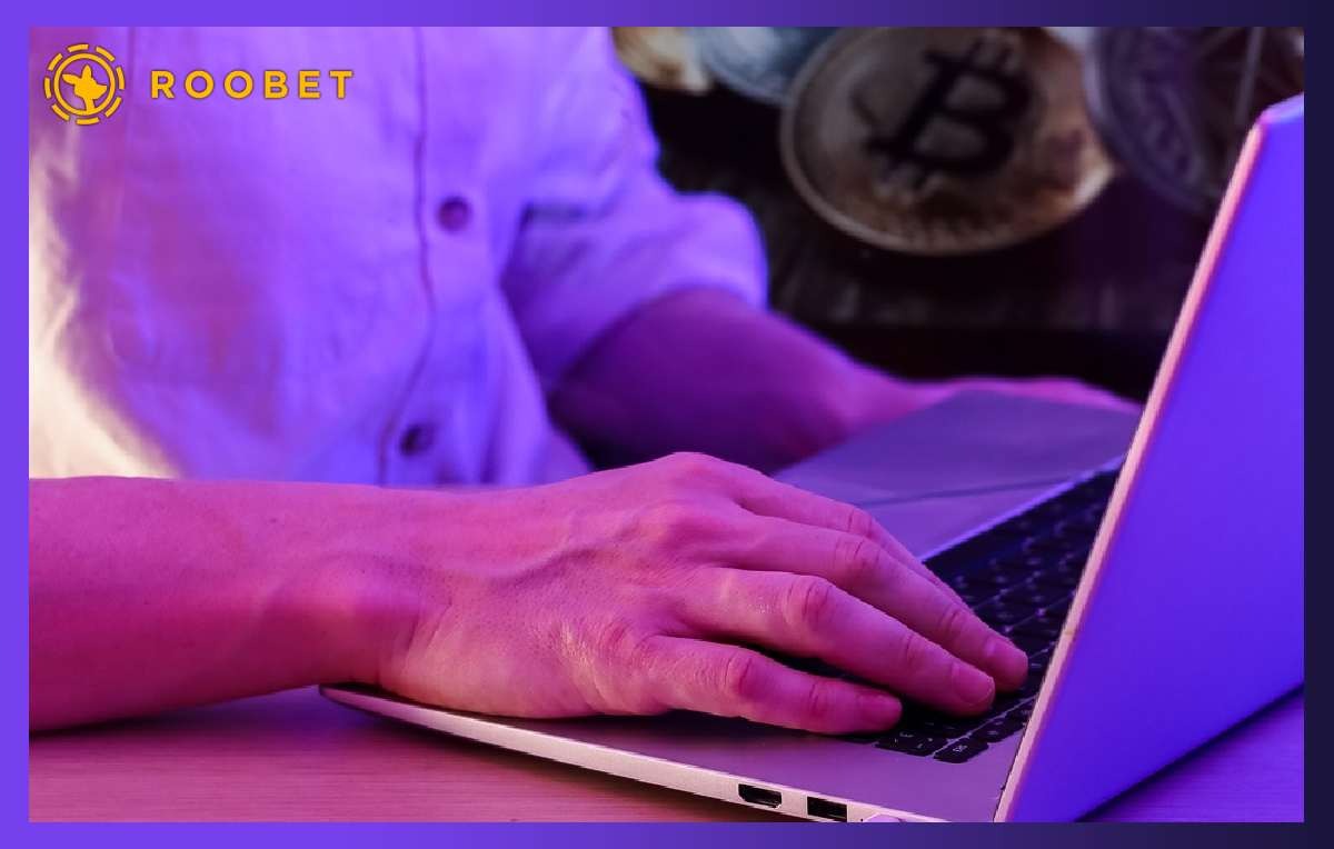 Bitcoin trader playing casino games on laptop
